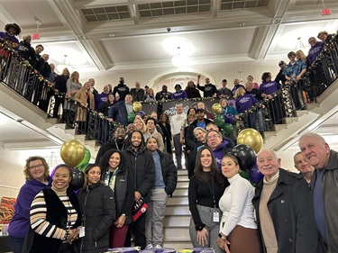 people on a staircase smiling for photo