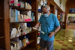 man holding library book