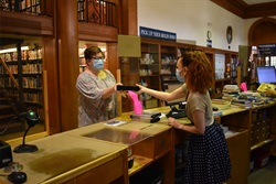 two woman at library check out