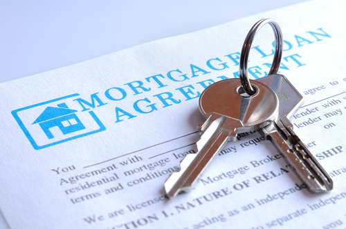 Set of keys and a mortgage agreement document